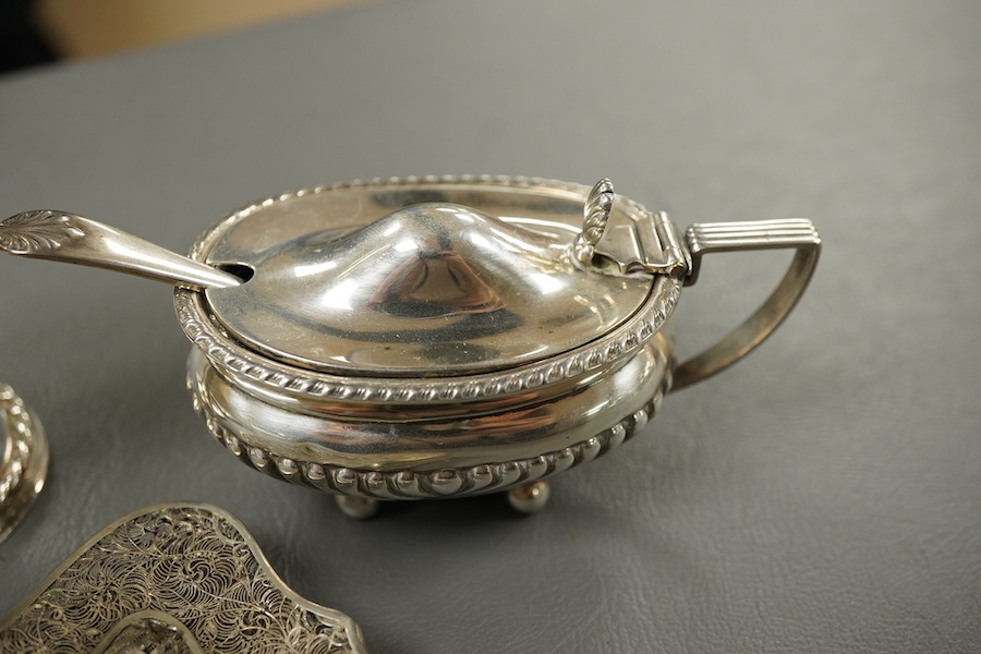A modern silver pepperette, Birmingham, 1988, 14cm, a silver mustard pot and associated silver spoon, a silver mounted notecase and a filigree white metal card case.